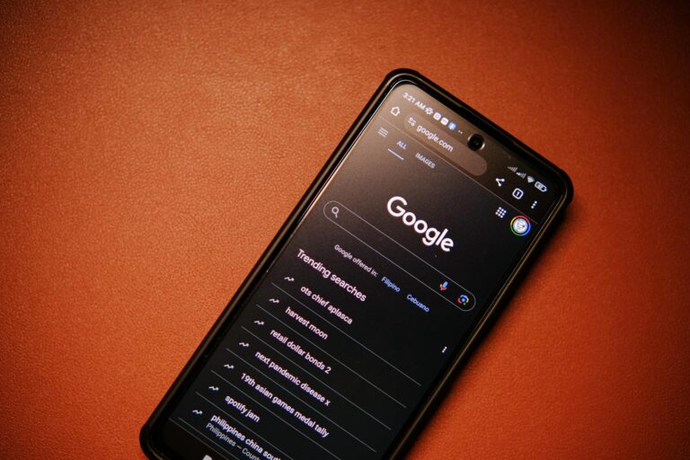 A smartphone displaying Google Search trends on a table at night.