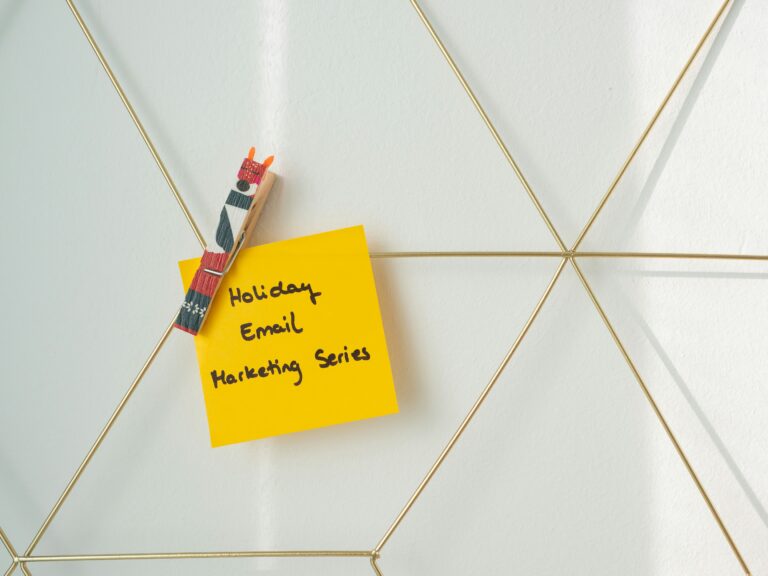a sticky note attached to a wall with a pen