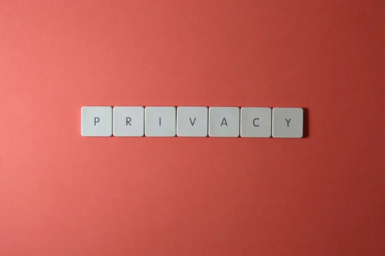 Close-up of letter tiles spelling PRIVACY on a red background, symbolizing data protection.
