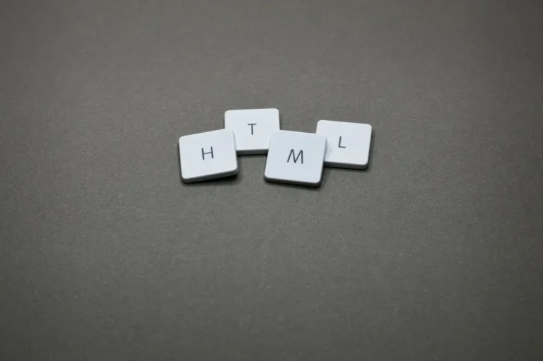 Minimalist image of HTML keycaps against a gray background, perfect for digital and web design themes.