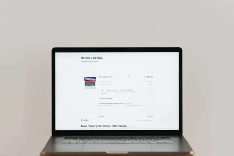 Minimalist laptop showing an online checkout screen on a white background, ideal for tech context.